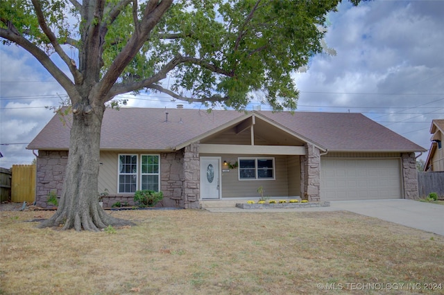 single story home featuring a garage and a front lawn