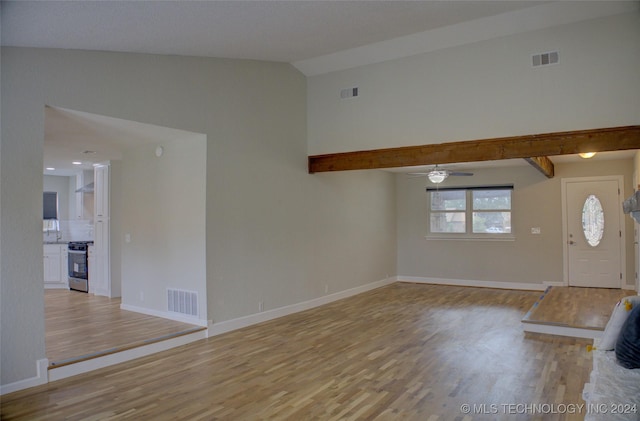 foyer entrance with vaulted ceiling, sink, ceiling fan, and light wood-type flooring