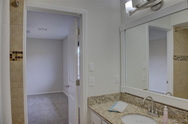 bathroom with vanity and a textured ceiling