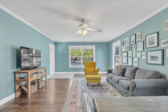 living room featuring dark wood-type flooring, crown molding, and ceiling fan