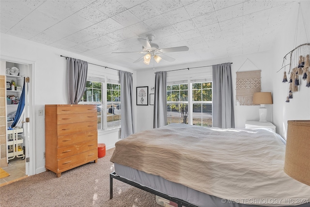 bedroom with ceiling fan and carpet