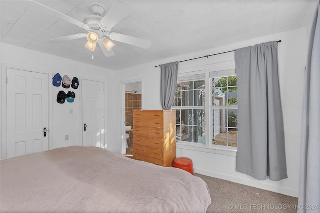 bedroom with connected bathroom, carpet, and ceiling fan