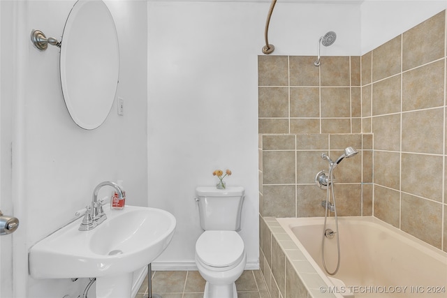 full bathroom with tiled shower / bath, tile patterned floors, sink, and toilet