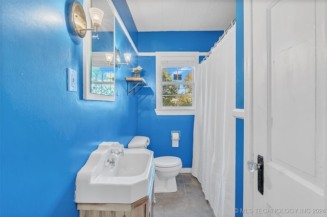 bathroom featuring toilet, vanity, and tile patterned floors