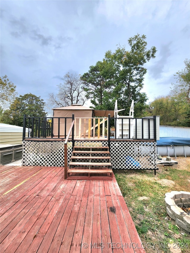 wooden deck with a covered pool