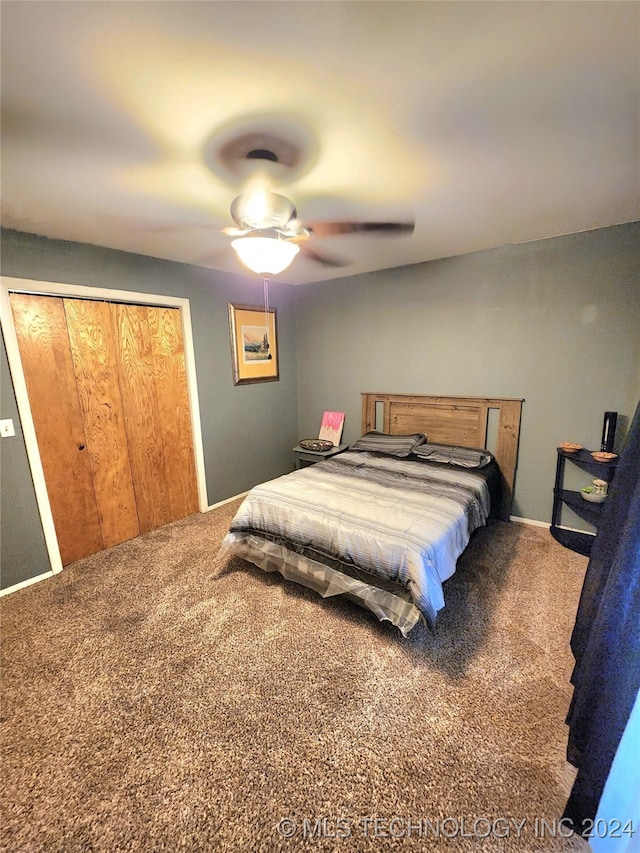 carpeted bedroom featuring ceiling fan and a closet