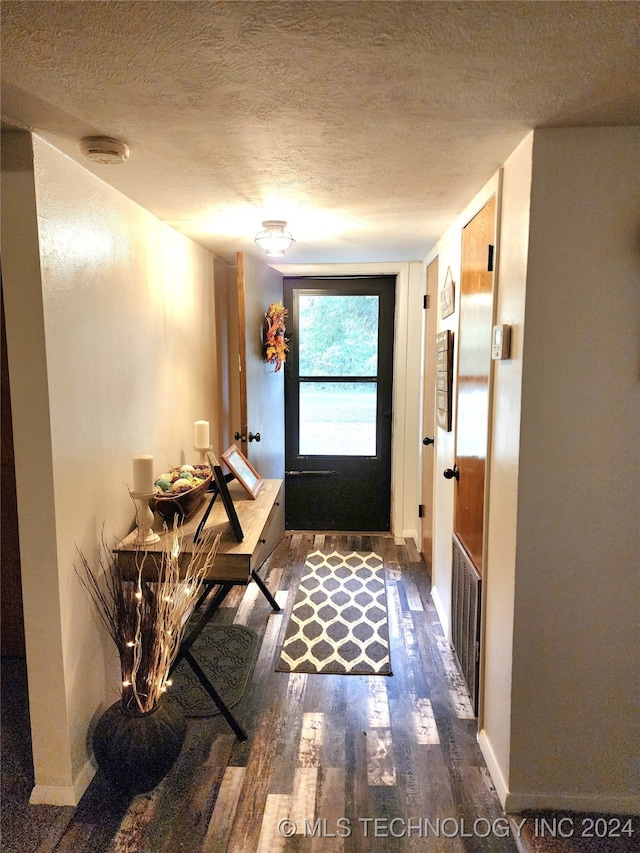 entryway featuring dark hardwood / wood-style floors and a textured ceiling