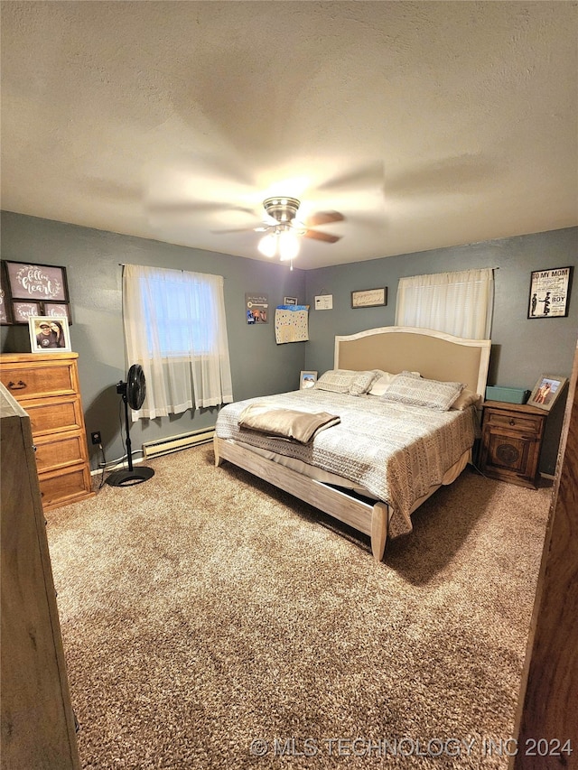 carpeted bedroom with ceiling fan, a textured ceiling, and a baseboard radiator