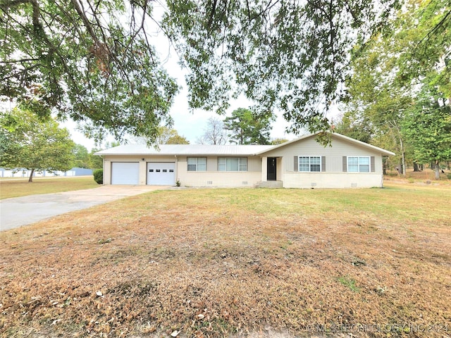 ranch-style home with a garage and a front lawn