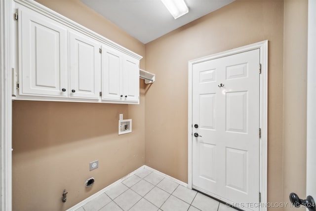 laundry area featuring hookup for a washing machine, hookup for an electric dryer, light tile patterned flooring, gas dryer hookup, and cabinets