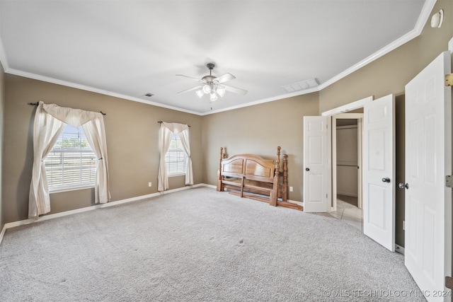 unfurnished bedroom featuring crown molding, multiple windows, light colored carpet, and ceiling fan