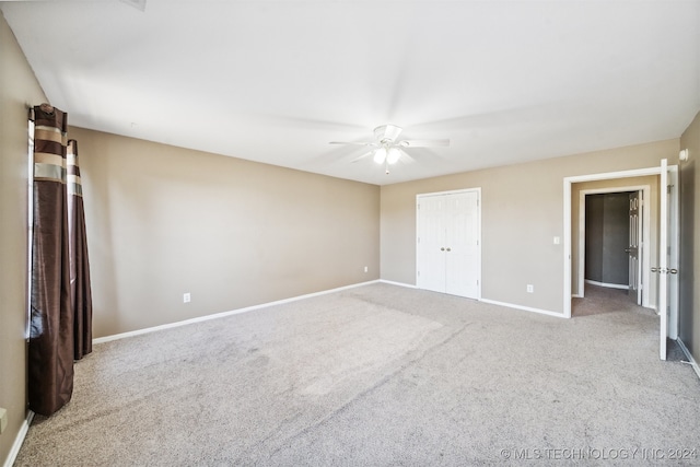 unfurnished bedroom featuring a closet, ceiling fan, and light carpet