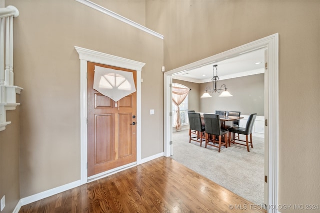 foyer featuring crown molding and wood-type flooring