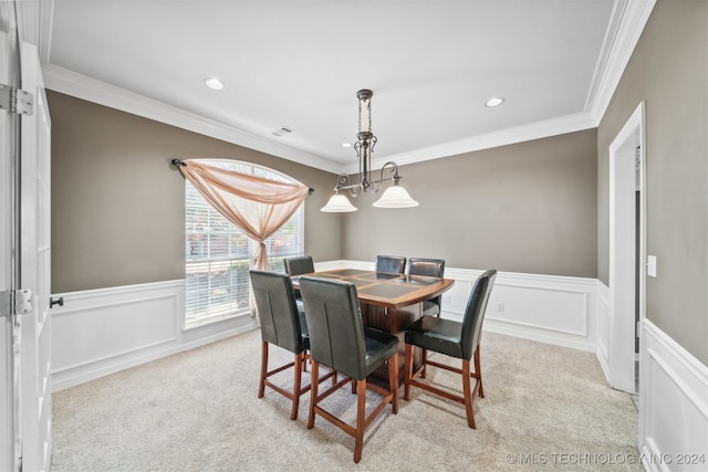 carpeted dining room featuring ornamental molding