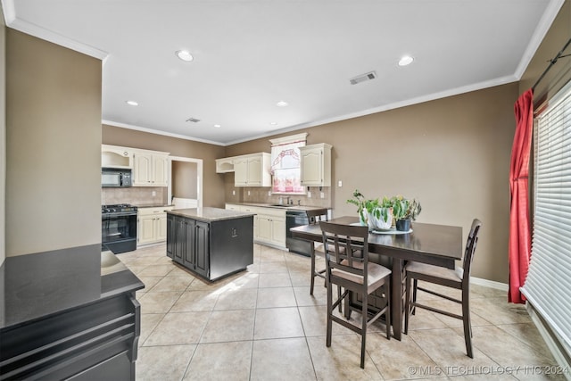 kitchen with a center island, tasteful backsplash, black appliances, and plenty of natural light