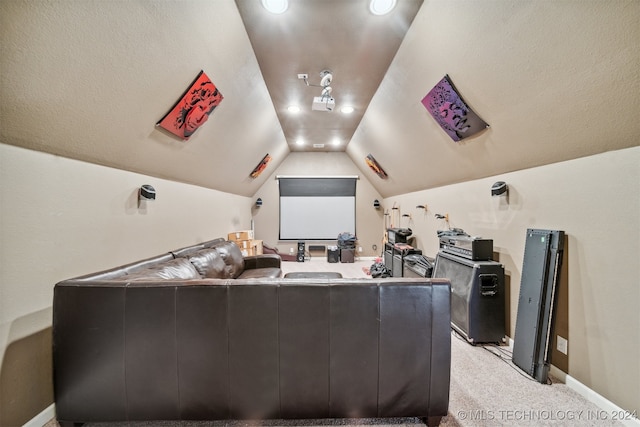 carpeted home theater room featuring vaulted ceiling