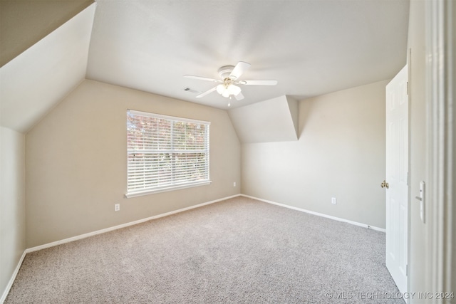 additional living space with carpet, vaulted ceiling, and ceiling fan