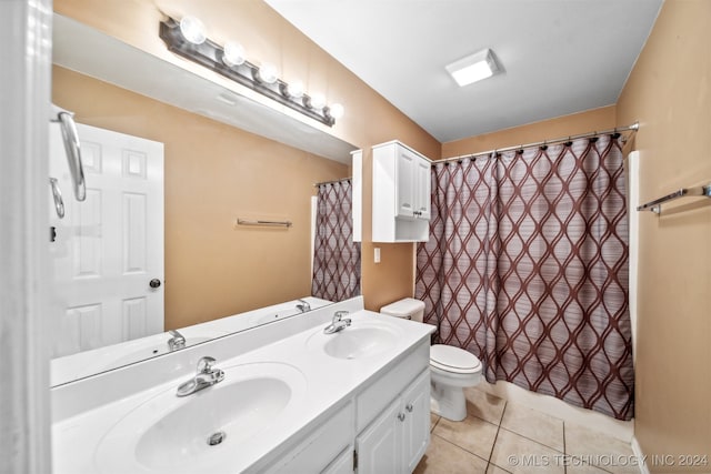 bathroom with vanity, toilet, and tile patterned floors