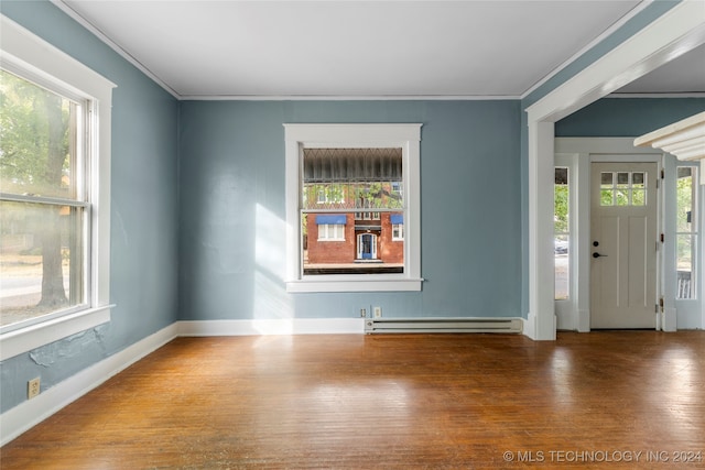 foyer with crown molding, hardwood / wood-style floors, and baseboard heating