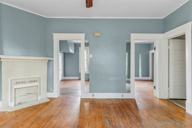 unfurnished living room with ornamental molding, hardwood / wood-style flooring, and ceiling fan