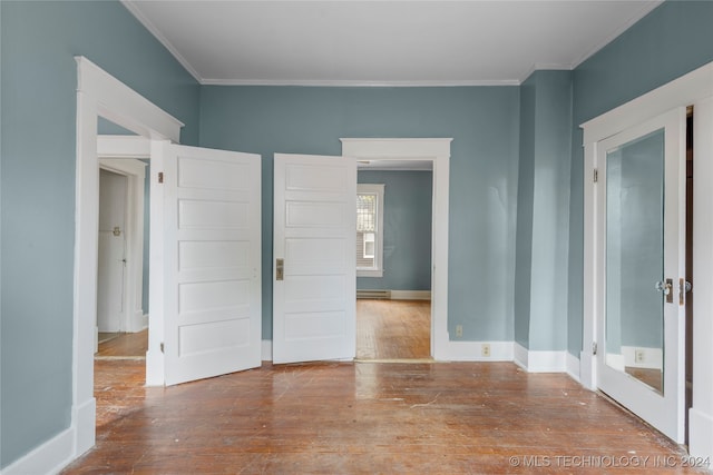 unfurnished bedroom with crown molding and light hardwood / wood-style flooring