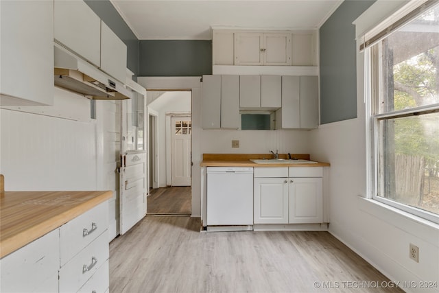 kitchen featuring white dishwasher, wooden counters, and a wealth of natural light