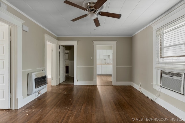 unfurnished living room featuring ceiling fan, ornamental molding, heating unit, and dark hardwood / wood-style floors