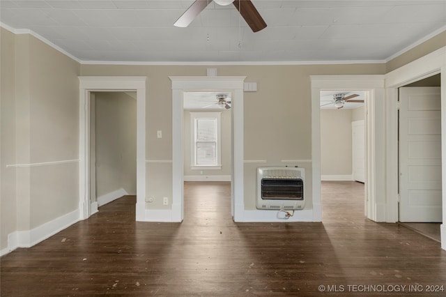 unfurnished living room with ornamental molding, dark wood-type flooring, and heating unit