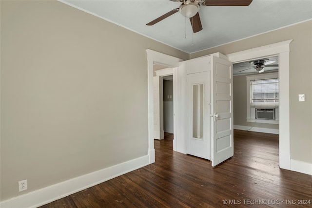 empty room featuring dark wood-type flooring, cooling unit, and ceiling fan