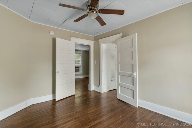 unfurnished room featuring ceiling fan and dark hardwood / wood-style flooring