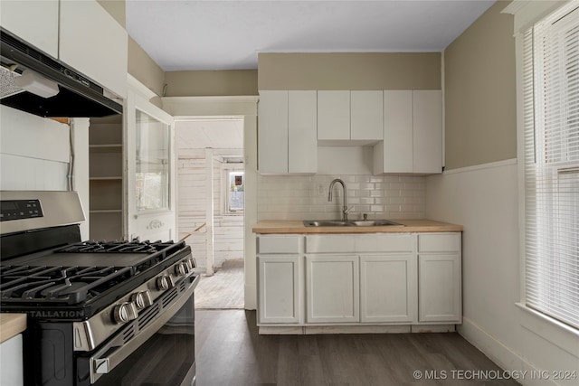 kitchen featuring decorative backsplash, dark hardwood / wood-style flooring, white cabinetry, stainless steel range with gas stovetop, and sink