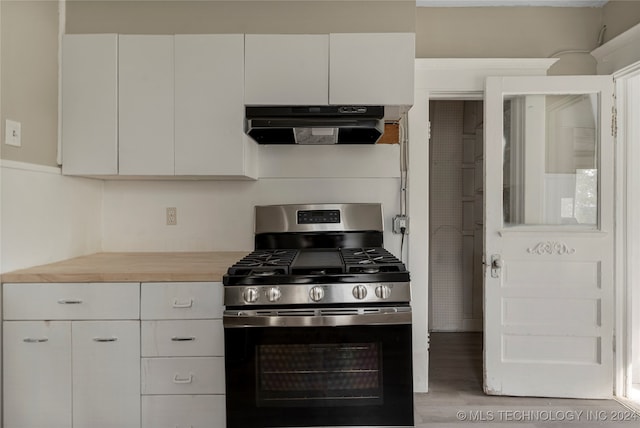 kitchen featuring hardwood / wood-style flooring, gas stove, butcher block countertops, and white cabinets