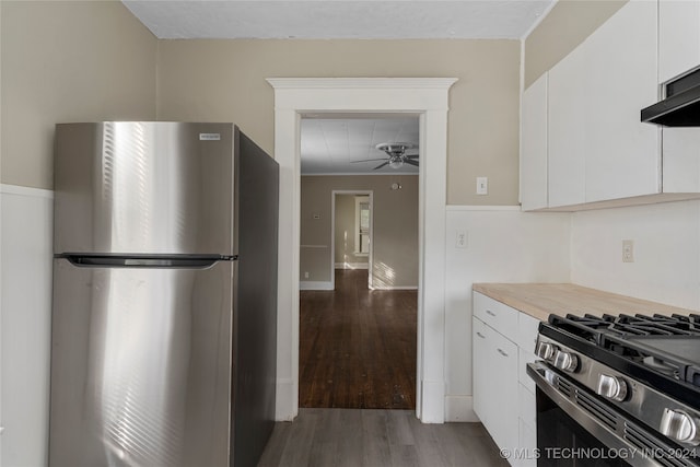 kitchen with white cabinets, stainless steel appliances, wood-type flooring, and ceiling fan