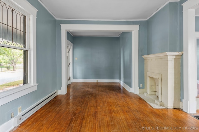 unfurnished living room with crown molding, a baseboard heating unit, and wood-type flooring