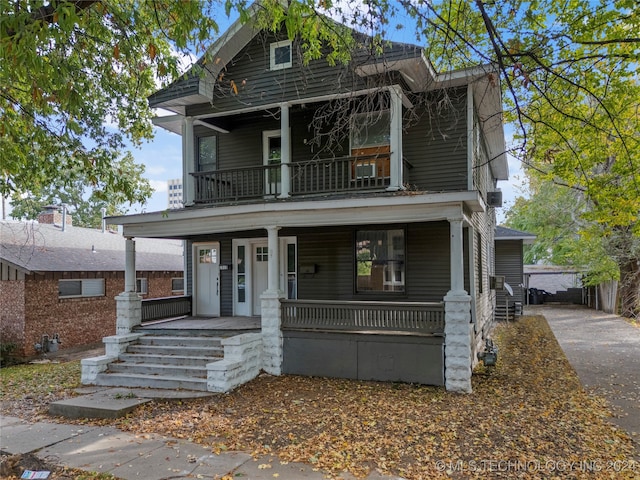 view of front of property featuring covered porch and a balcony