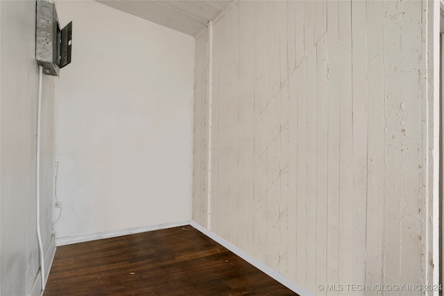 interior space featuring hardwood / wood-style floors and wooden walls