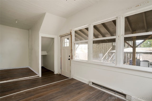 entrance foyer with dark wood-type flooring, vaulted ceiling, a baseboard heating unit, and a healthy amount of sunlight