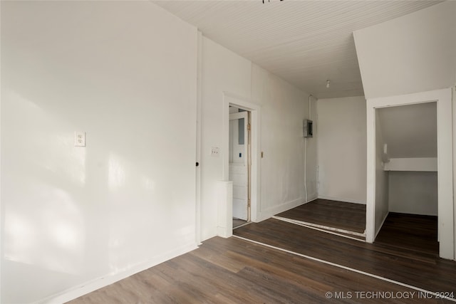 corridor with dark hardwood / wood-style flooring