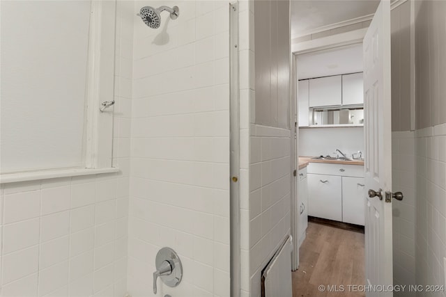 bathroom featuring vanity, tiled shower, and hardwood / wood-style floors