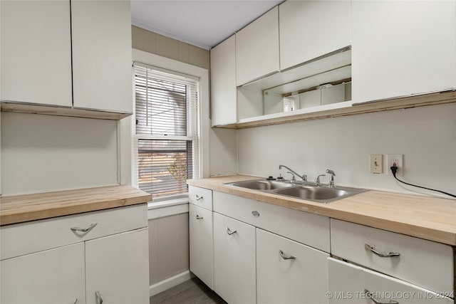 kitchen featuring white cabinetry and sink