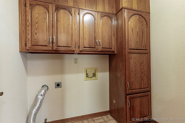 laundry room with cabinets, hookup for a washing machine, gas dryer hookup, and electric dryer hookup