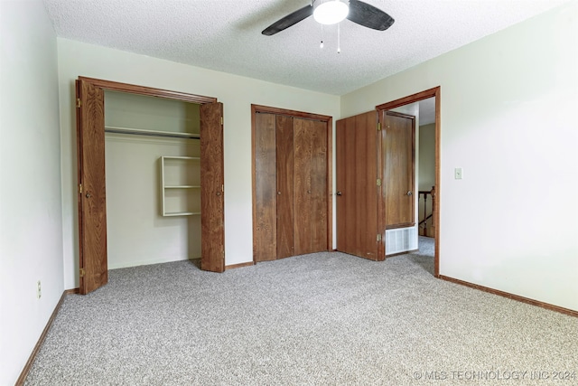 unfurnished bedroom with a textured ceiling, light colored carpet, and ceiling fan