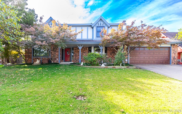 view of front of home with a front yard and a garage