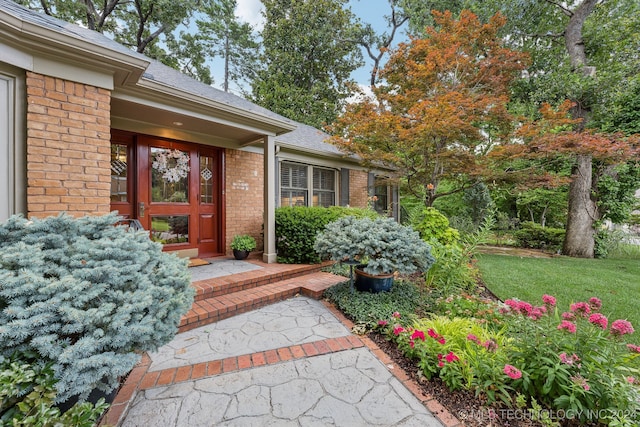 property entrance with a yard