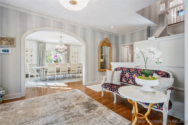 living area with a notable chandelier and hardwood / wood-style flooring