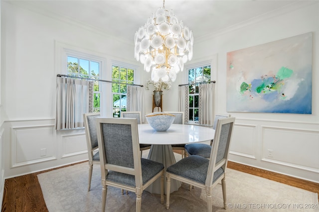 dining space featuring a notable chandelier, hardwood / wood-style flooring, and crown molding