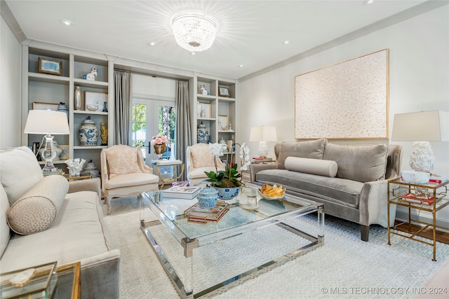 living room with french doors, a notable chandelier, and wood-type flooring