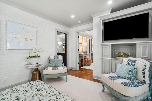 bedroom featuring ornamental molding and hardwood / wood-style flooring