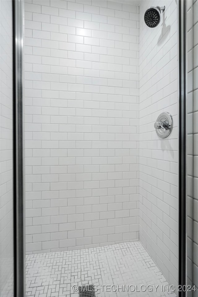 bathroom with a shower with shower door