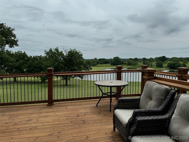 125 Falconhead Unit E, Burneyville, OK 73430 - wooden deck with a water view and a lawn